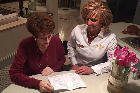 Caregiver and elderly lady Reading