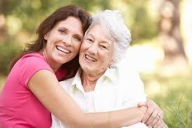 Caregiver and elderly lady huging